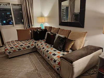 Comfortable L-shaped Brown/Beige sofa with Cushions