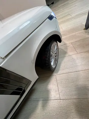 White battery-powered ride-on car for kids — perfect condition
