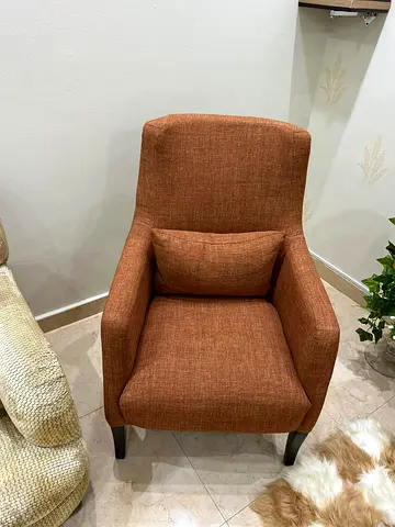 Comfortable orange upholstered accent armchair with cushion