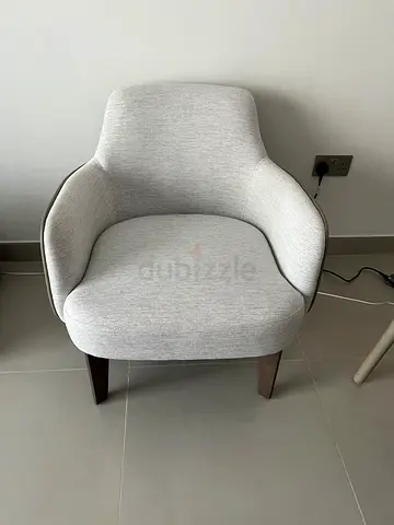 Light grey upholstered accent armchair with wooden legs