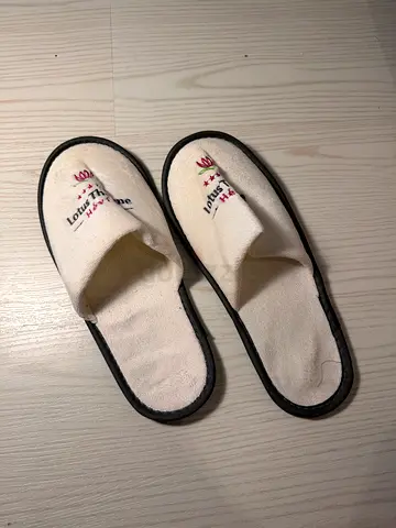 Pair of white hotel-style slip-on slippers