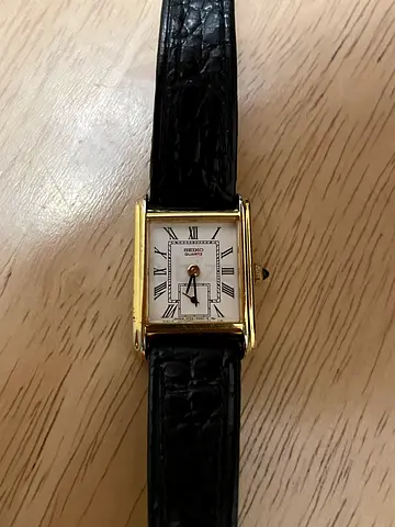 Seiko Tank gold-tone wristwatch with black leather strap