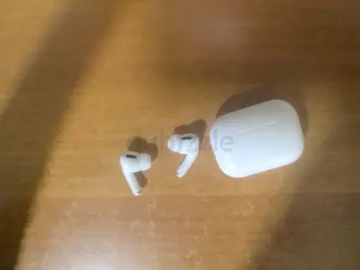 Used wireless earbuds with charging case (looks like AirPods-style) - good condition