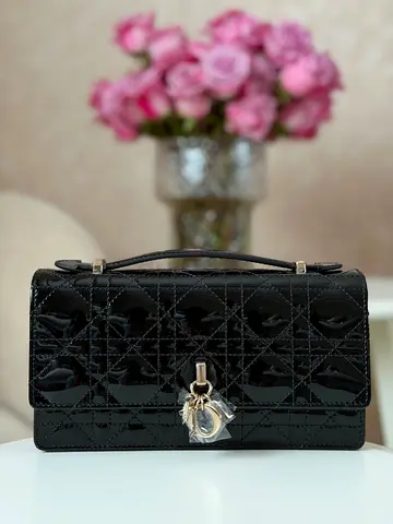 Black patent leather top-handle designer-style clutch bag
