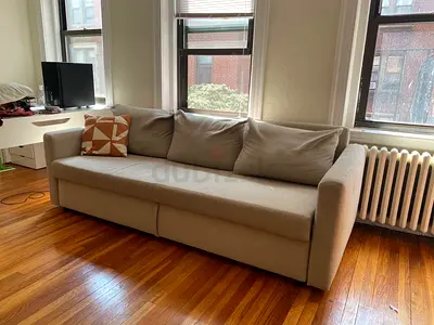 Simple beige 3-seater sofa bed  in good condition