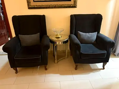 Pair of dark grey upholstered wingback armchairs - good condition