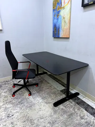 Modern black office desk with ergonomic swivel chair - good condition