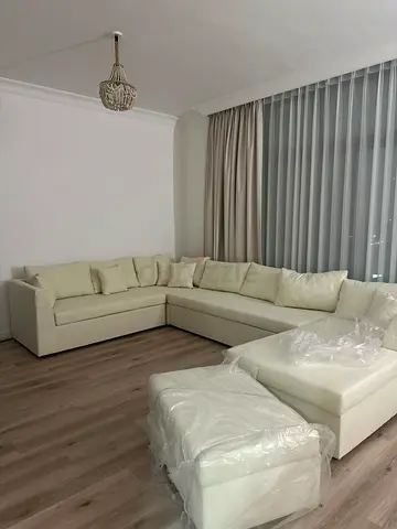 Large L/U shaped cream sectional sofa for (8-10) with TV unit