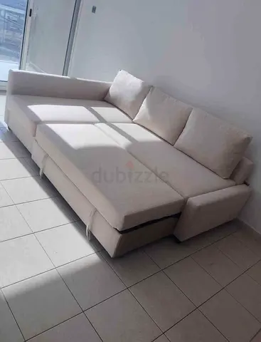 Light beige L-shaped sofa bed with storage, good condition