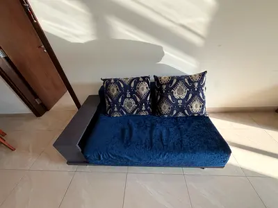 Compact navy blue single-seater sofa with side wooden armrest