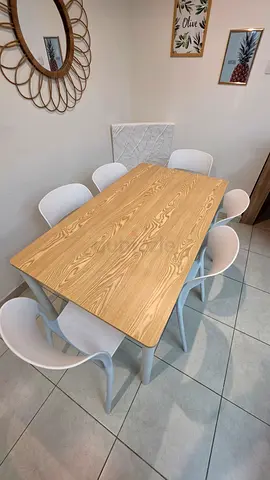 Light wood dining table with 6 white modern chairs