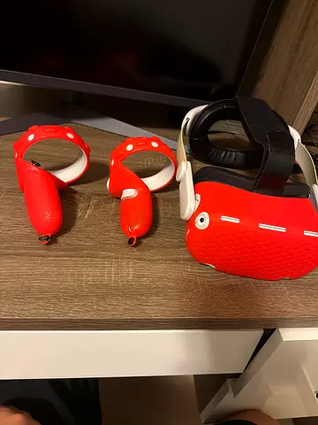 Meta Quest 2 VR headset with red controllers (used) - good condition with comfort pad