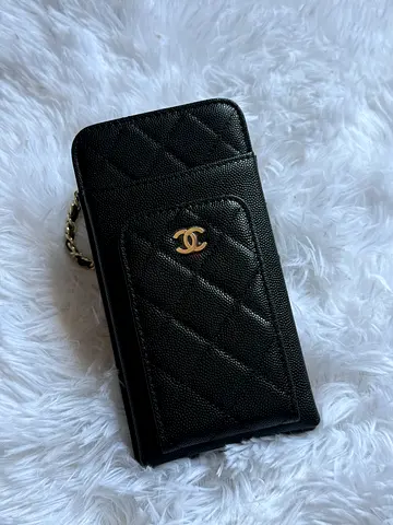 Black quilted Chanel-style phone pouch with chain
