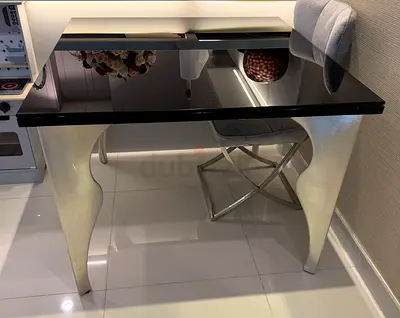 Modern black glass dining table with sculpted white legs - good condition