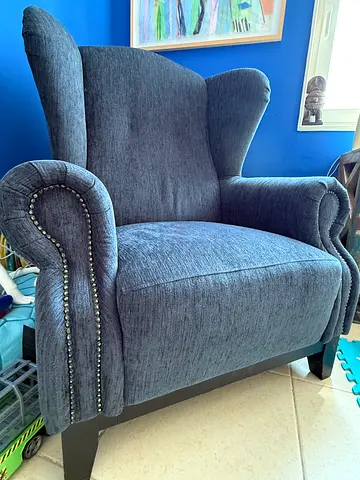 Dark blue armchair with nailhead trim