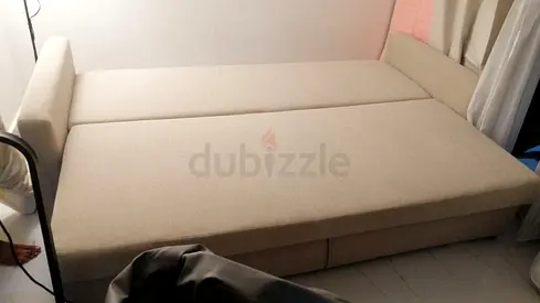 Beige pull-out sofa bed in good condition