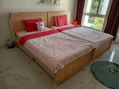 Pair of single wooden beds with headboards - light oak finish