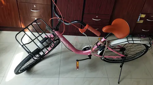 Pink ladies bi cycle with front basket — used, good condition