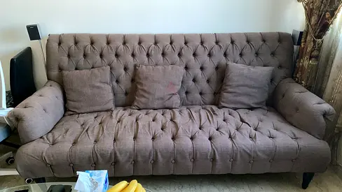 Brown tufted 3-seater fabric sofa bed with cushions