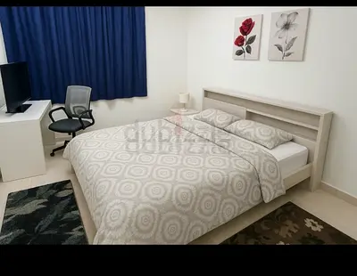 Queen bed frame with built-in headboard shelves - light wood, good condition