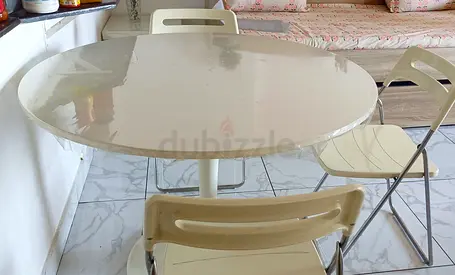 Elegant white color round shape dining table with 3 chairs.for sale.