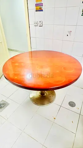 Round wooden dining table with brass pedestal - good used condition