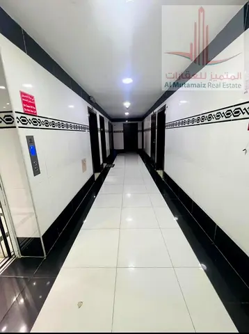 One-bedroom apartment with a living room, two bathrooms, . Prime location facing Al Nuaimiya Park; new building, families only.