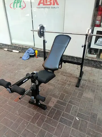 Adjustable weight bench with barbell and leg developer - used