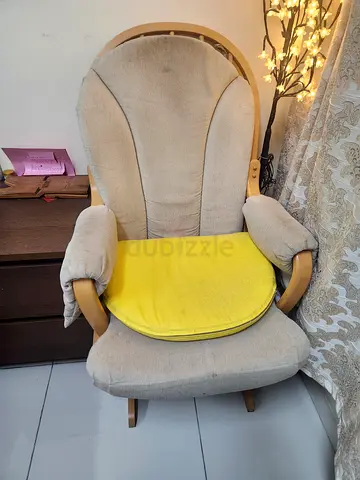 Comfortable beige upholstered armchair with wooden frame