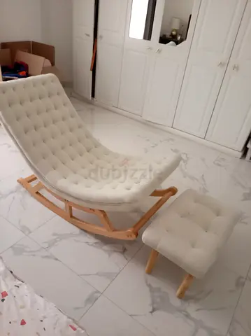 Comfortable tufted rocking lounge chair with matching footstool