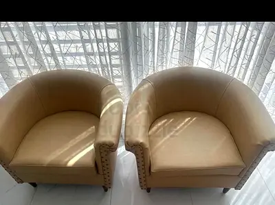 Beige leather tub armchair in good condition