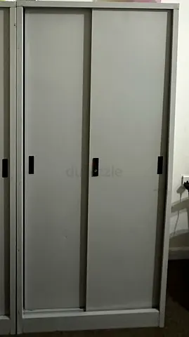 Grey metal office storage cabinet with sliding doors
