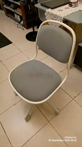Used grey upholstered office or study chair with wheels — good for home study