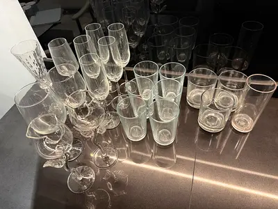 Set of assorted clear drinking glasses and wine/champagne flutes