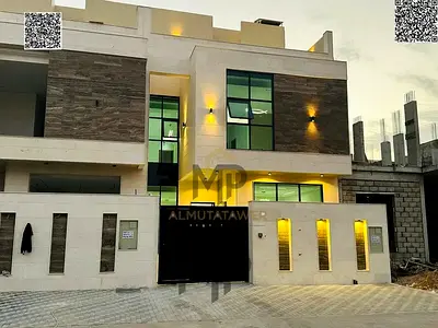 Luxury villa for sale in Al Helio 2 – Ajman, featuring a premium stone façade and modern design. It comprises 5 master bedrooms, two floors plus a roo