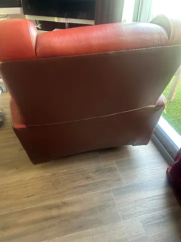 Used red leather armchair in good condition