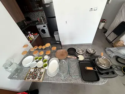 Mixed kitchenware set — pans, bakeware, dishes, and serving pieces