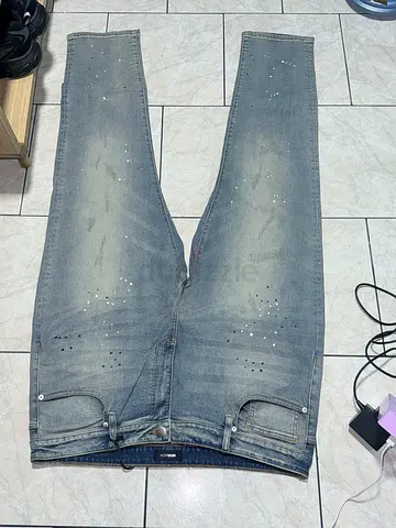 Slim fit men's light-wash distressed jeans, size approx 42