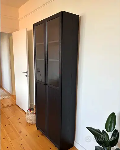 Tall dark wood cabinet with glass doors – good condition