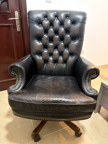 Vintage tufted black leather swivel armchair with nailhead trim