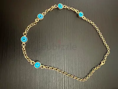 Gold-tone necklace with blue evil eye and medallion charms non tarnished 10k plated