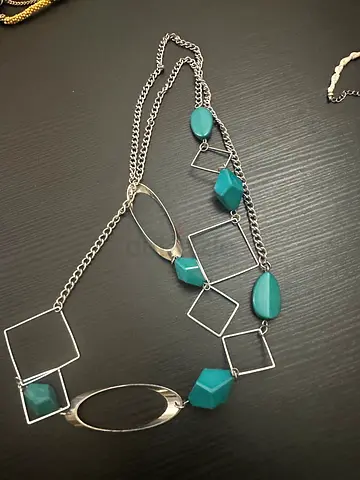 Long geometric pendant necklace with teal and silver accents