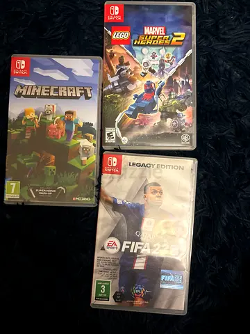 Three Nintendo Switch games — Minecraft, FIFA 23 (Legacy), LEGO Marvel Heroes 2