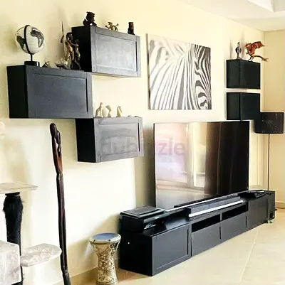 Black modular wall-mounted entertainment unit with TV stand