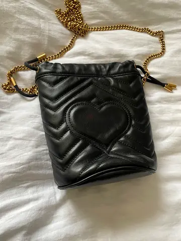 Black quilted leather crossbody bag with gold chain strap