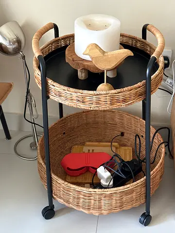Two-tier wicker and metal side table with wheels