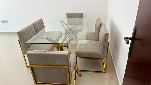 Glass Top Dining Table with 6 Grey Upholstered Chairs and Gold Frame