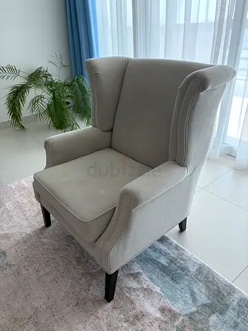 Light grey upholstered wingback armchair — good condition