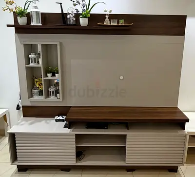 Modern wall-mounted TV entertainment unit with shelves and cabinets
