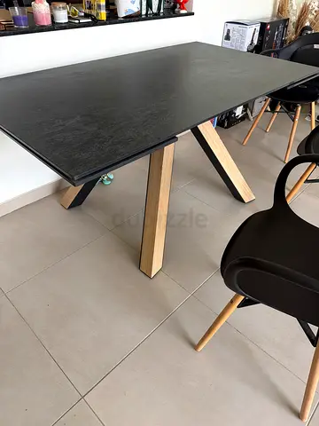 Modern black dining table with wooden legs - good condition